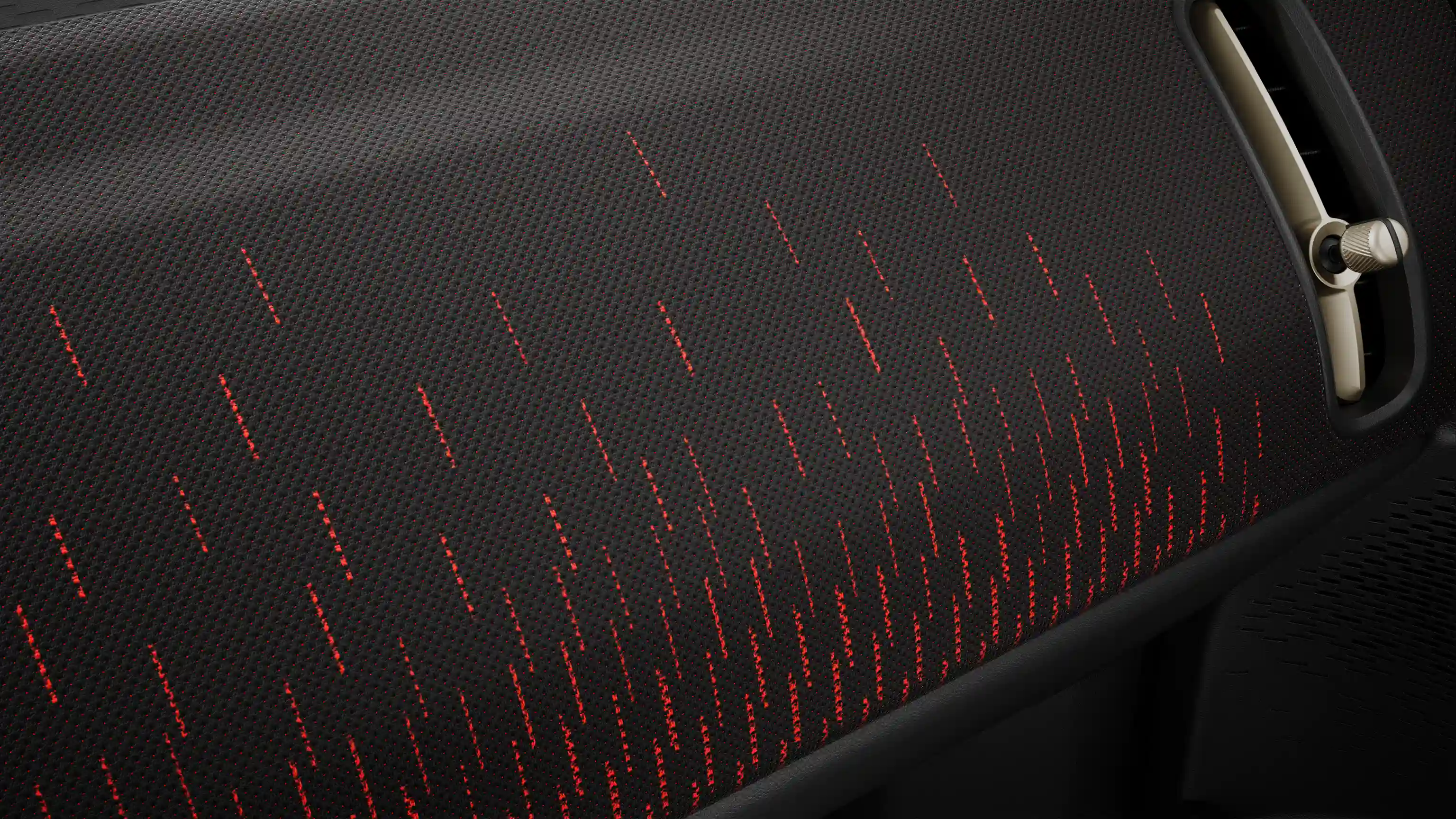 Изглед на таблото на напълно електрическо MINI Countryman в стил JCW в червено и черно